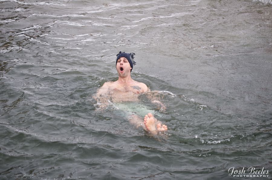 male swimmer wearig hat in Lake George in winter