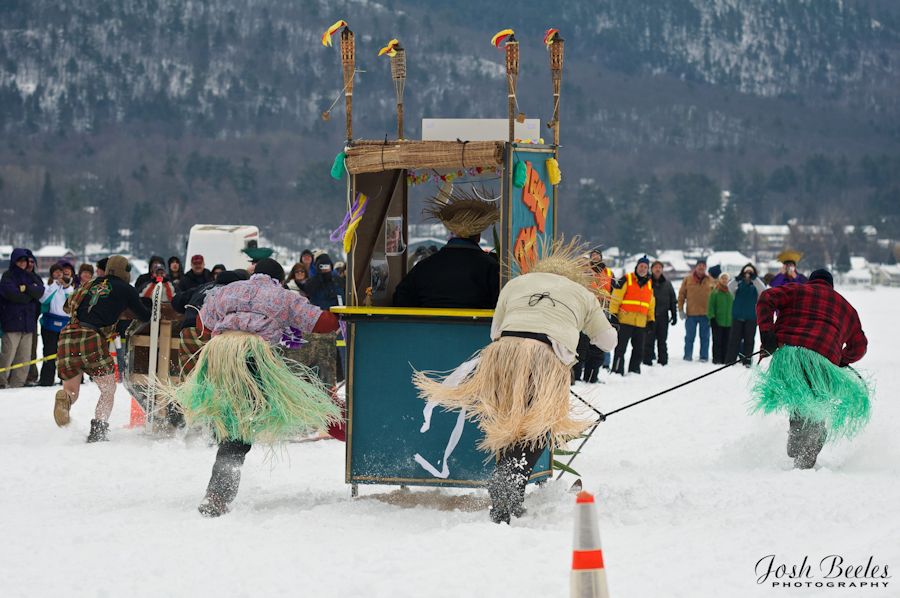outhouse race with team wearing hula skirts at Lake George carnival