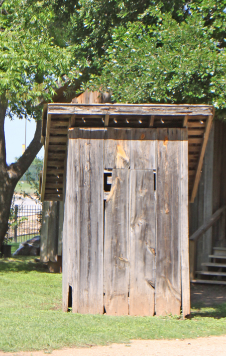 Mayborn Musuem in Waco, Texas exhibit showing outhouse in Bill and Vara Daniels Historic Village