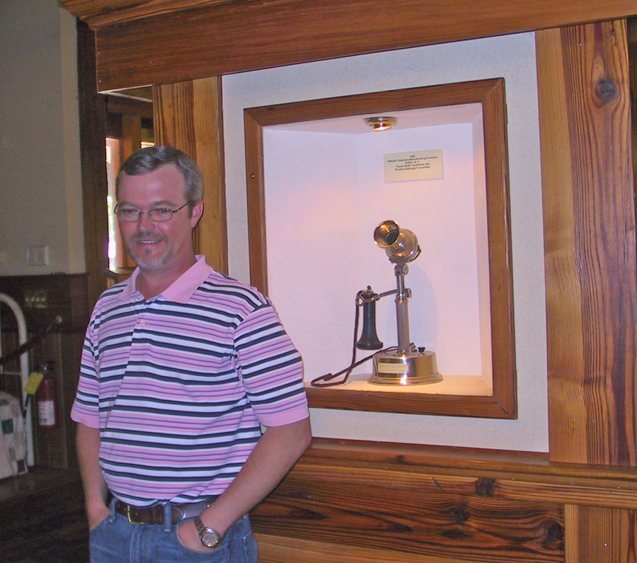 Clint Ledger in front of Wilhelm Candlestick phone at at the Georgia Rural Telephone Musuem in Leslie, Georgia
