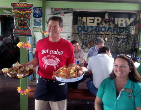 Waiter and Punta Gorda Mayor with seafood at Peace River Seafood 