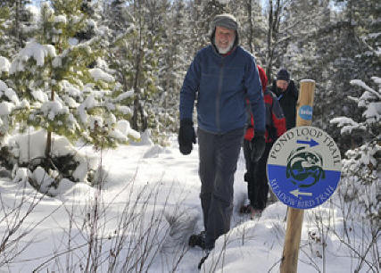 Man hiking in snow  at Wild Center in Adirondacks