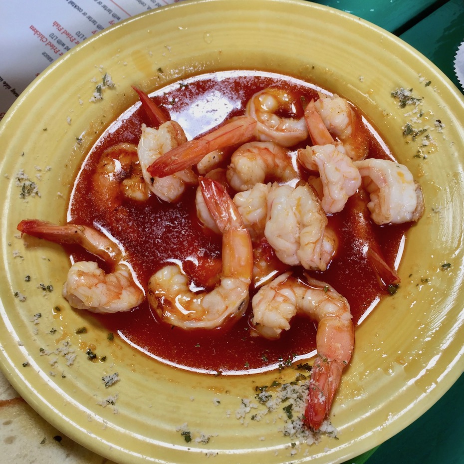 Shrimp in red sauce on yellow plate