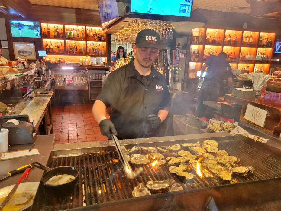 chef charbroiling oysters