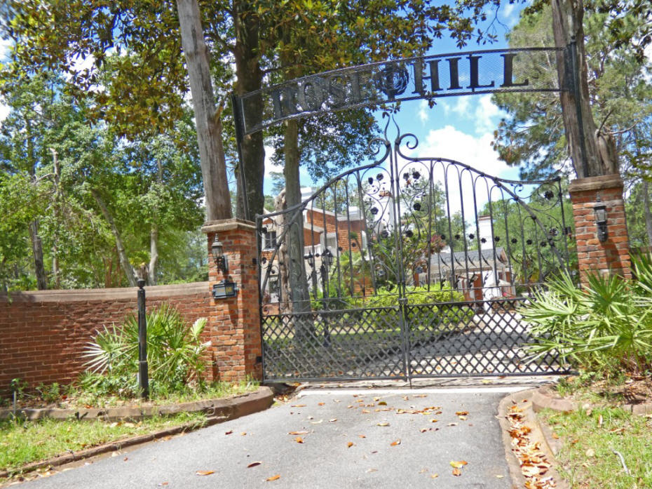 gate at rose hill with house in background