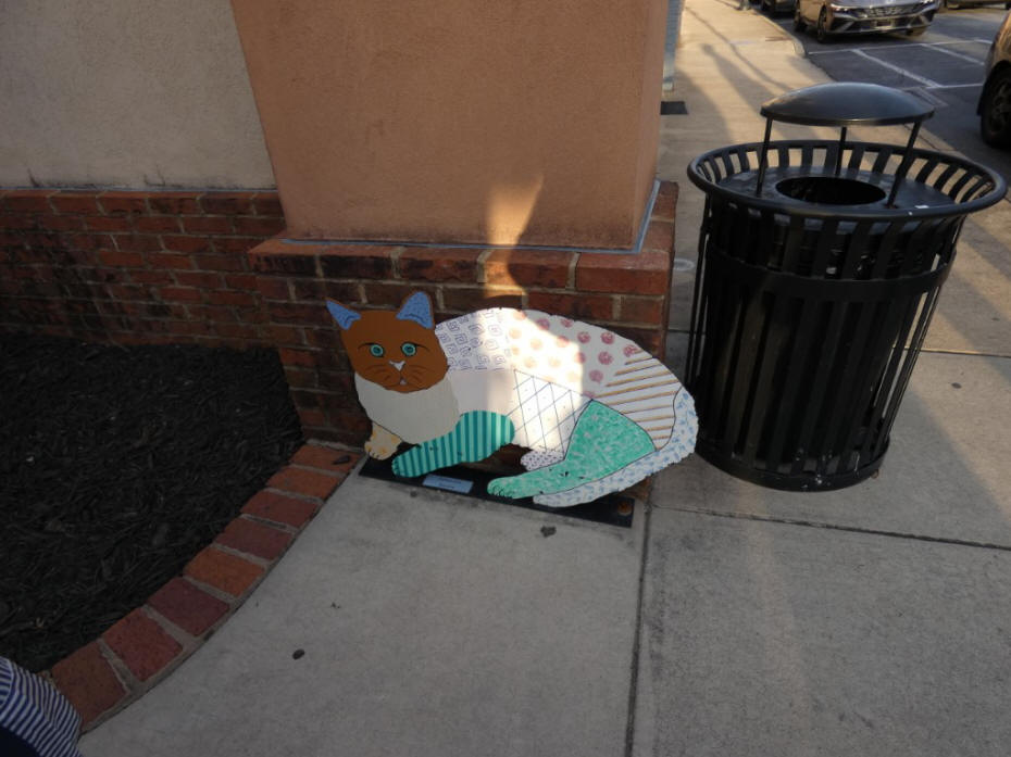 metal painted cat on sidewlk