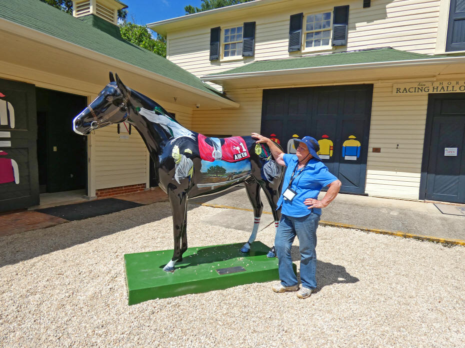 hall of fame with author petting painted hors in front