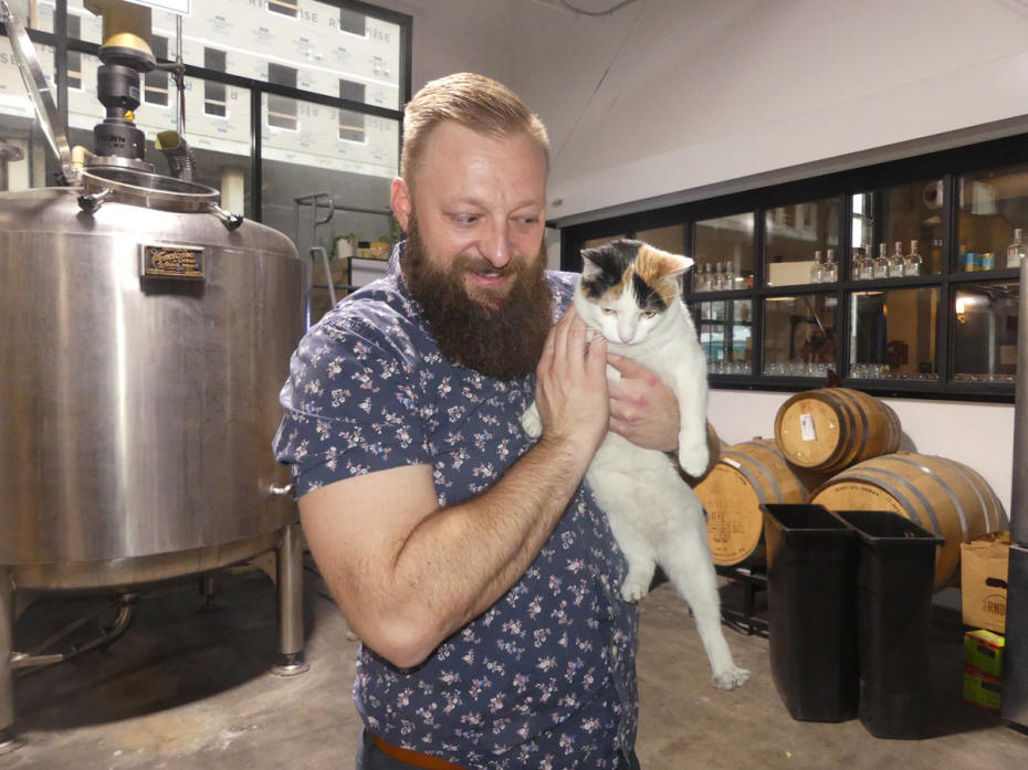 guide wiht distillery cat at manifest distilling