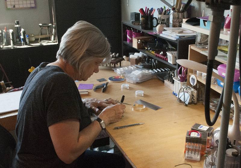 Artist Donna miller working at The Purple Pomegranate in Whitefish, Montana