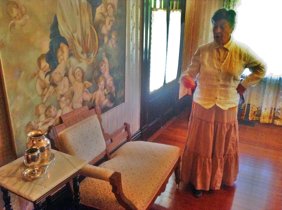 docent shows off furnishings at Tift House at Georgia Agrirama