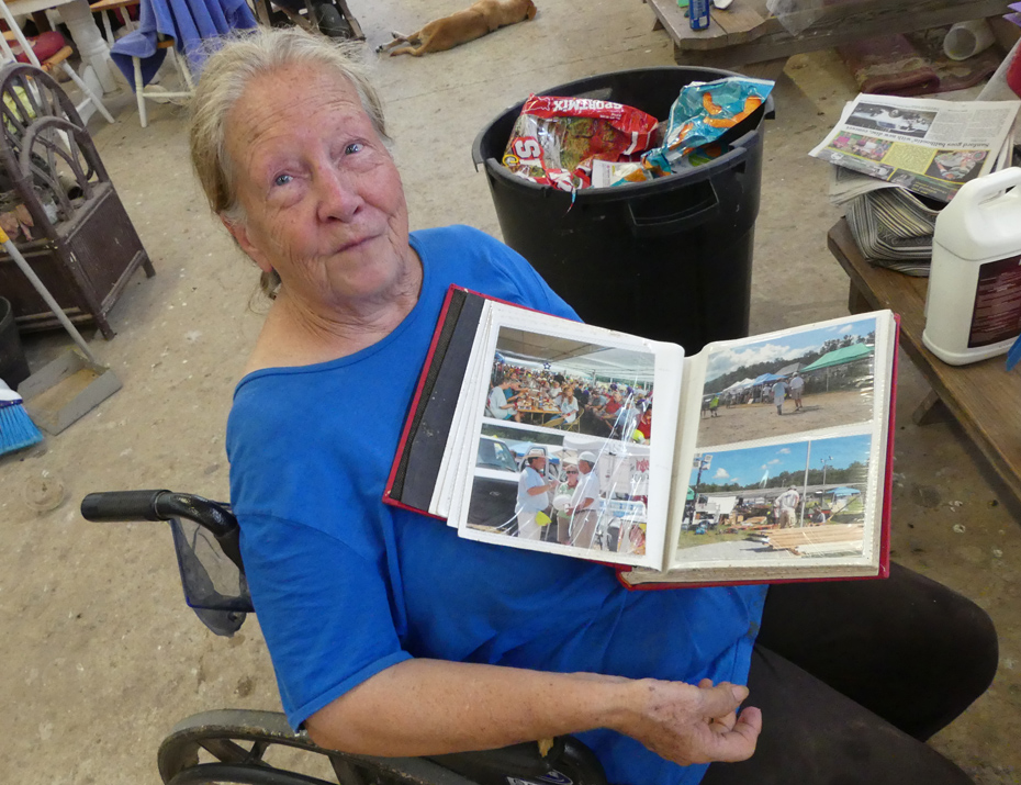 woman in wheelchair showing scrapbook