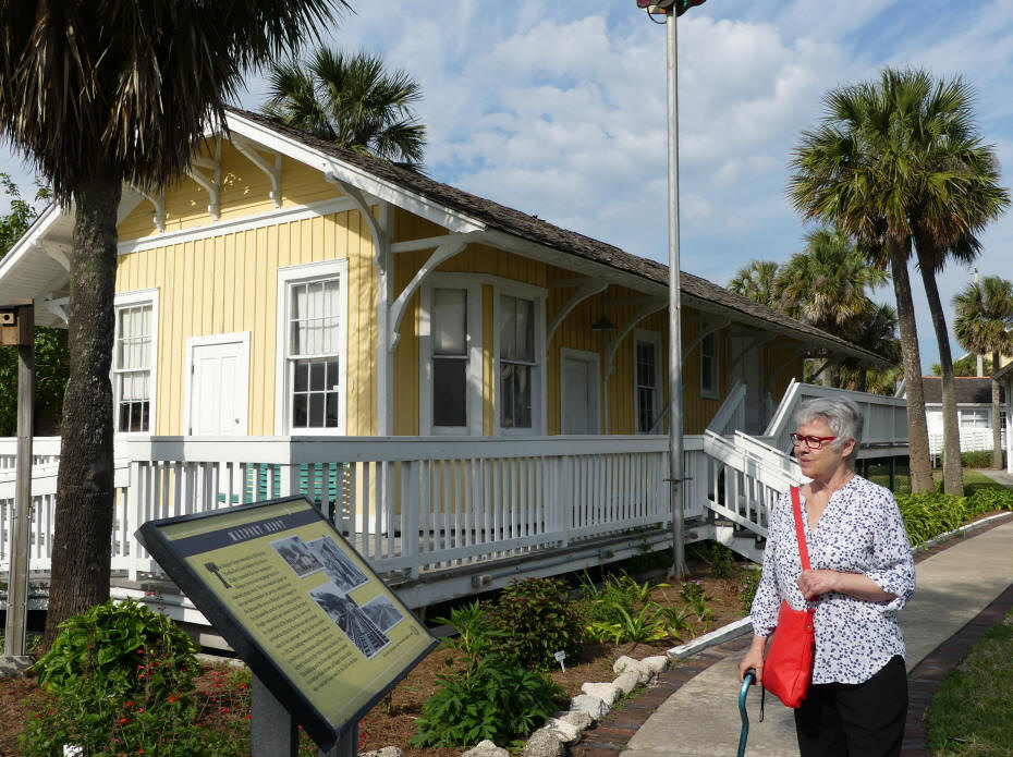 lady looking at historic home in park