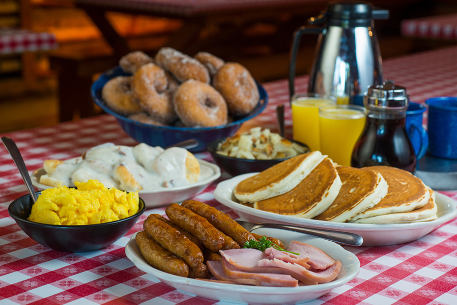 breakfast of donuts, eggs, bisquits, sausage, and pancales