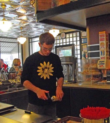 server scooping ice cream at Borden’s Ice Cream Shoppe in Lafayette, Louisiana