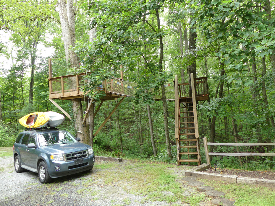 tree house wiht car and kayaks