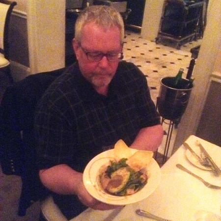 Man holding Satsuma Advacado Salad at Broussard’s Restaurant in New Orleans