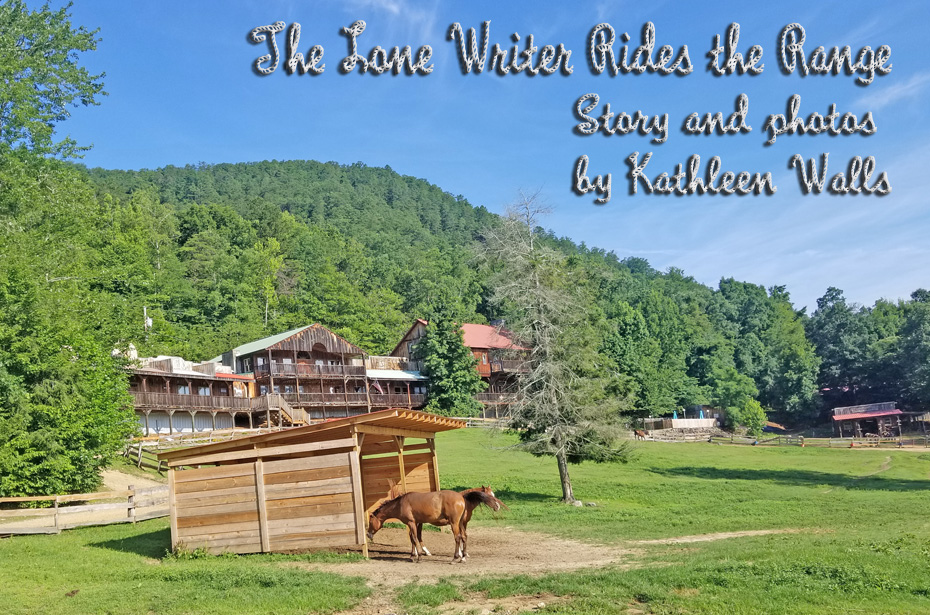 French Broad Outpost Dude Ranch in Eastern Tennessee with horses graxing in pasture and what appears like an old west town in background