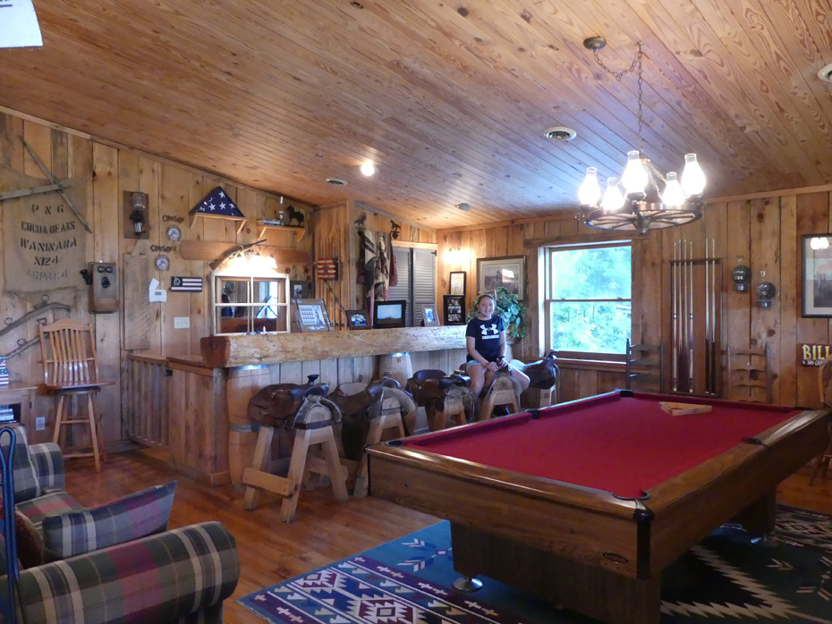 Young girl sseated at bar in game room at French Broad Outpost Dude Ranch in Eastern Tennessee