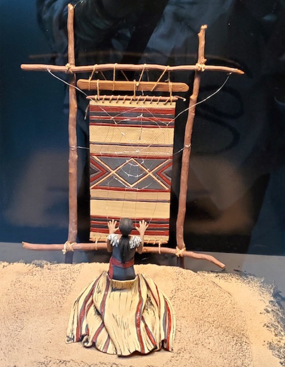 exhibit of Navajo woman weaving at a loom