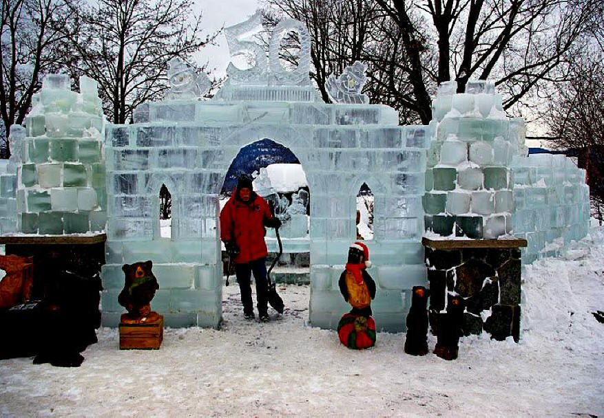 Chainsaw artist wiht castle he created at  Lake George carnival