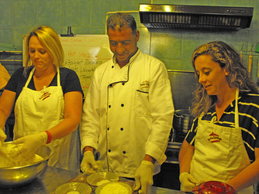 chef assists two momen wiht bread making at Petra Kitchen