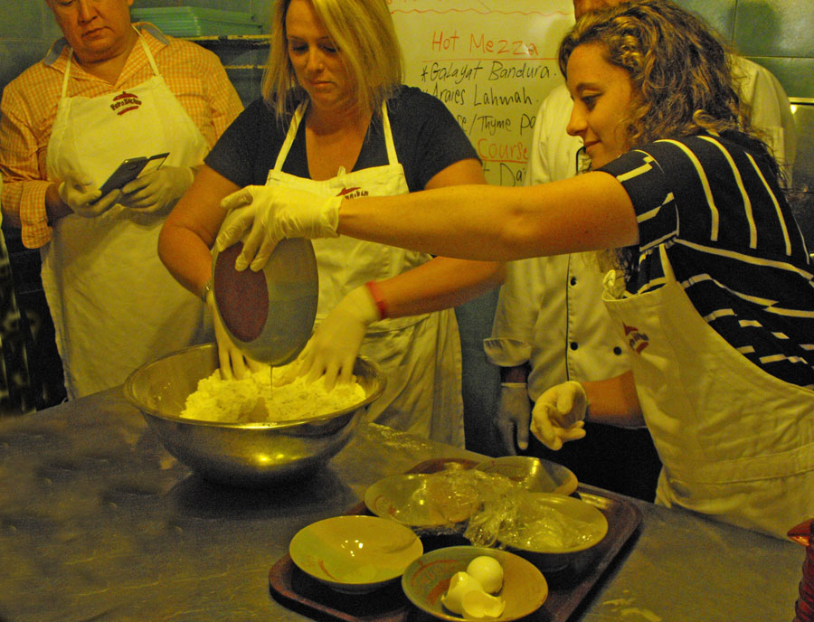 four peole contribute to bread making at Petra Kitchen
