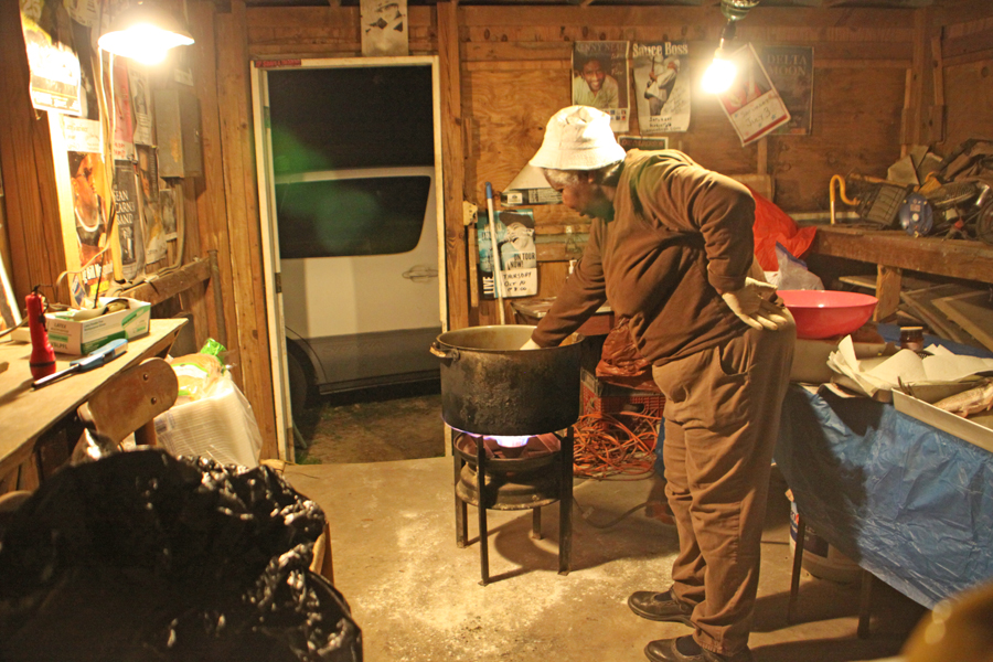 woman frying fish at wook hut ibehind Bradfordville Blues Club