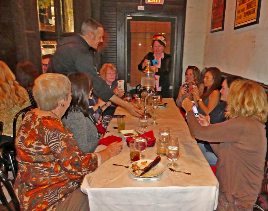 group seatedat tale being served drinks