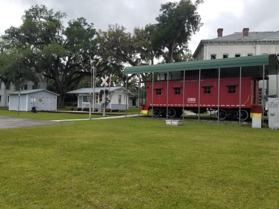 caboose in front and old jail in background