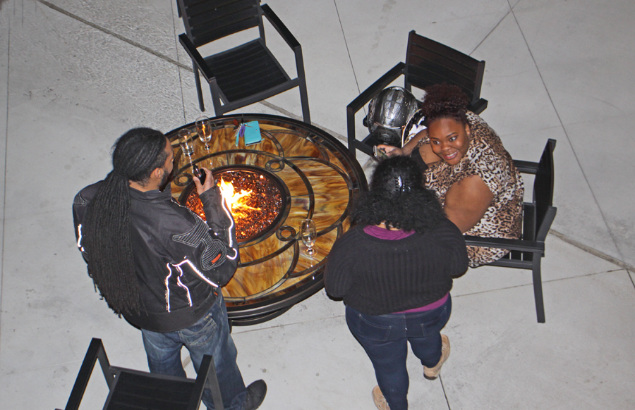 family gathered aroudn a firepit at the Deison in Tallahassee