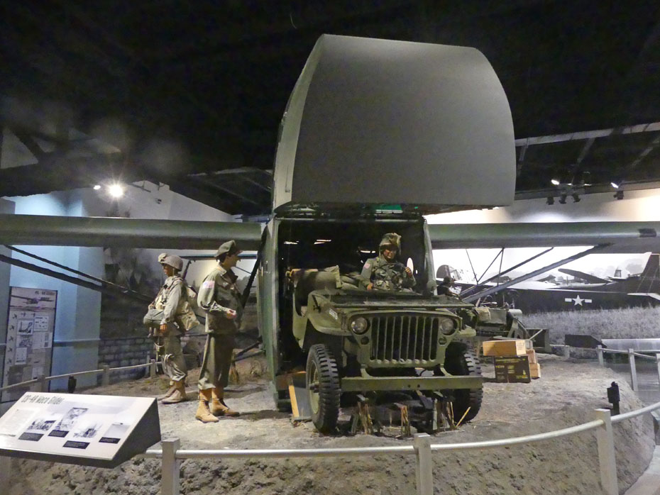 exhibit showing a glider unloading a jeep WWII era